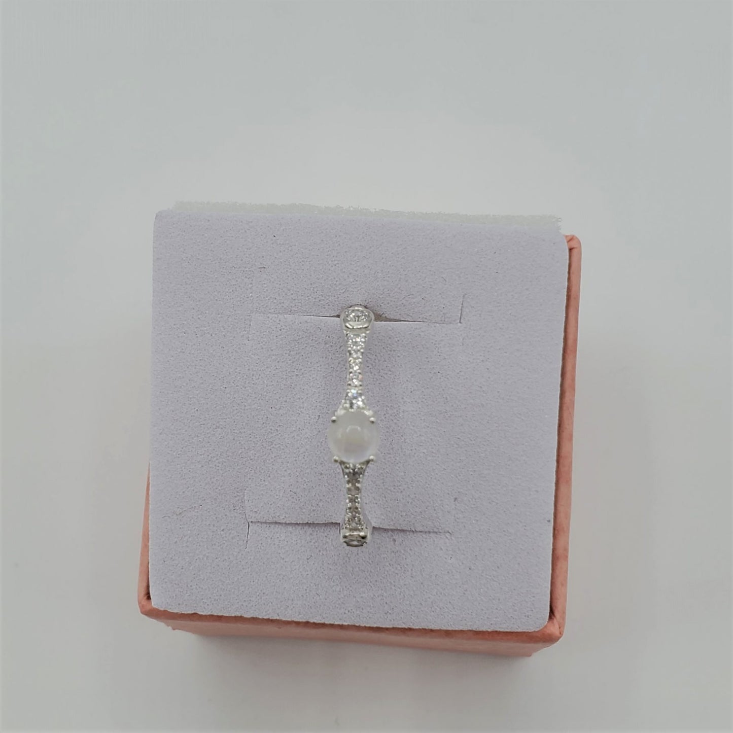 Delicate Moonstone ring with crystal accent stones.