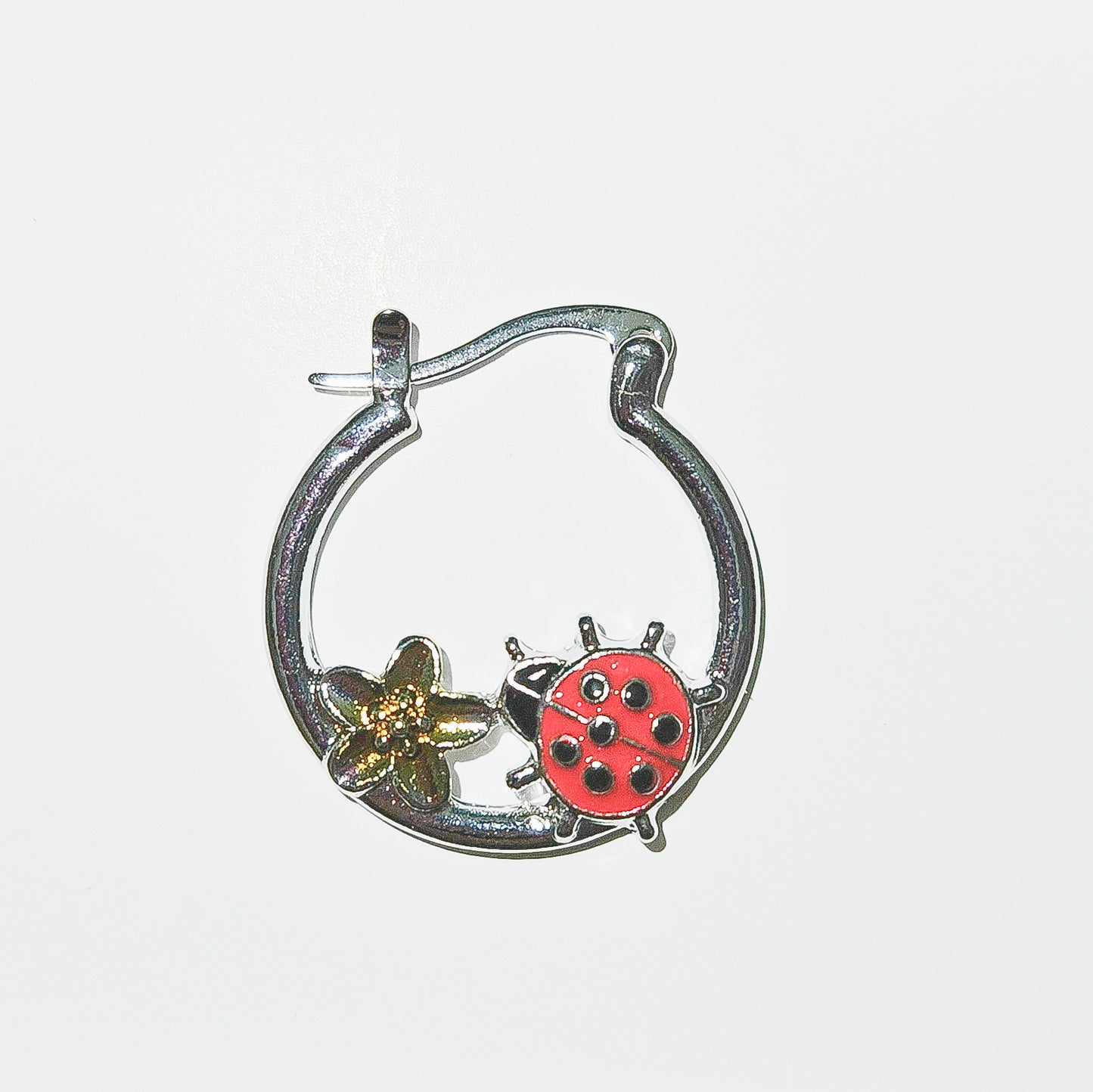 Ladybug hoop accented by a golden flower.