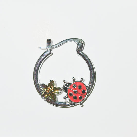 Ladybug hoop accented by a golden flower.