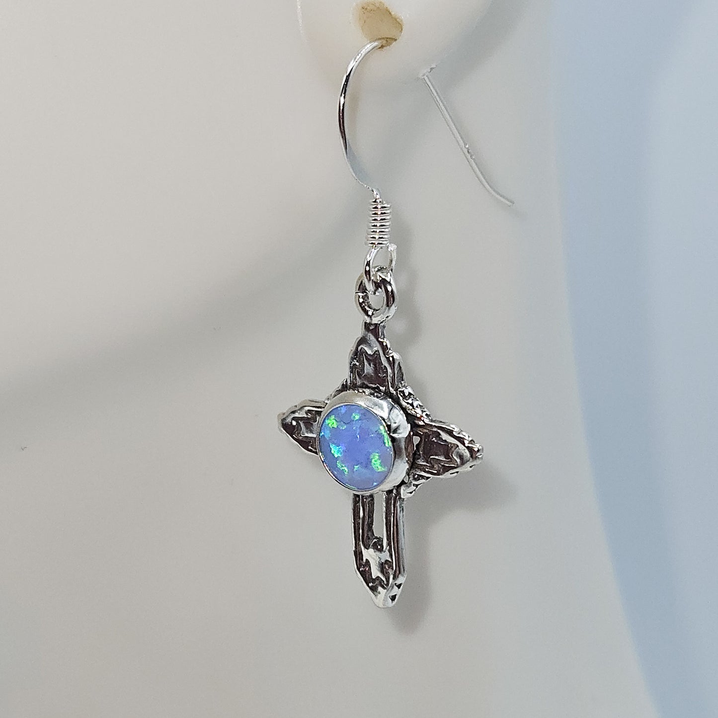 Southwestern Cross dangle earrings accented by a white opal