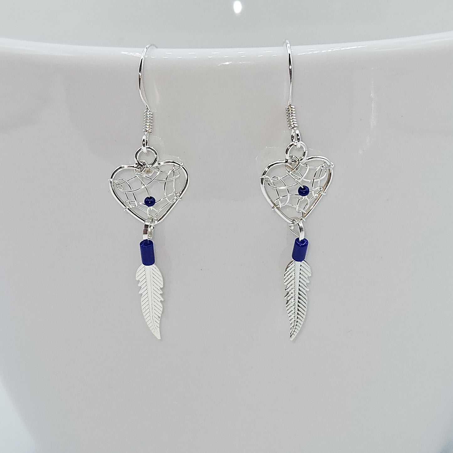 Heart shaped dream catcher dangle earring accented by lapis lazuli