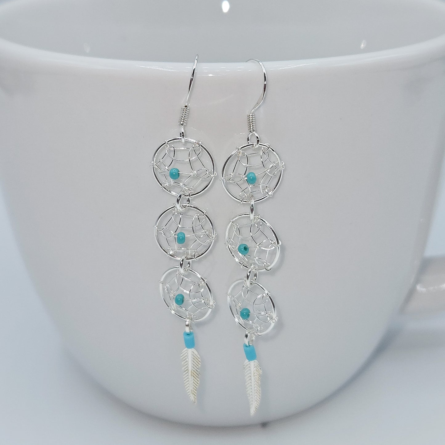 Dream Catcher earrings accented by turquoise beads