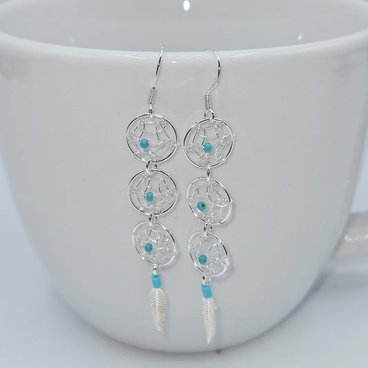 Dream Catcher earrings accented by turquoise beads