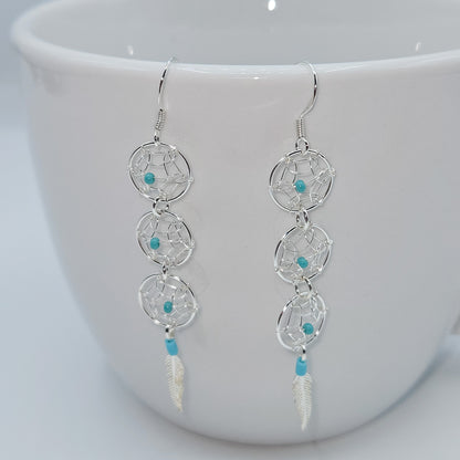 Dream Catcher earrings accented by turquoise beads