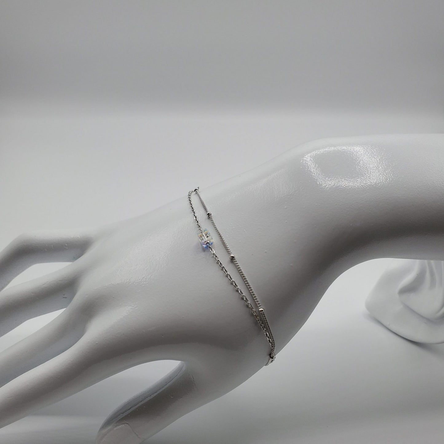 Minimalist floating crystal cube on a double chain bracelet