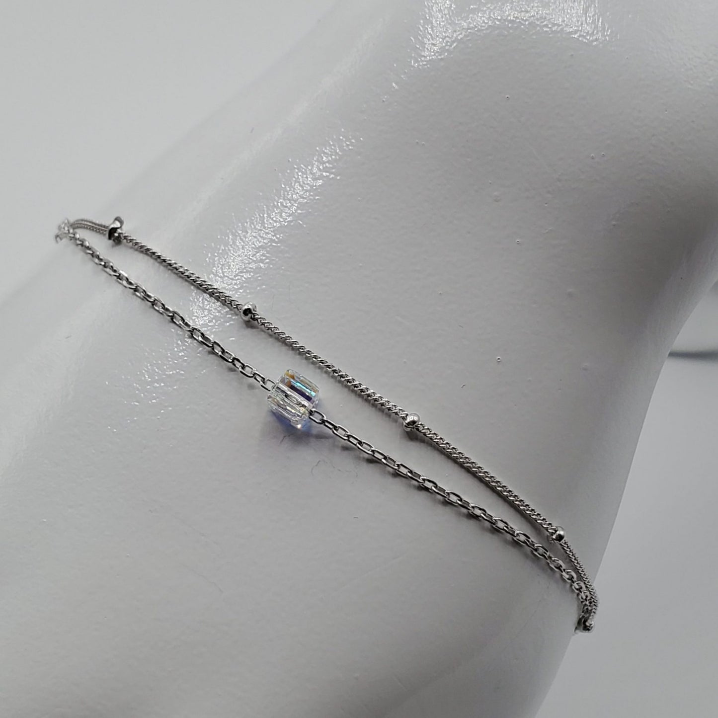 Minimalist floating crystal cube on a double chain bracelet