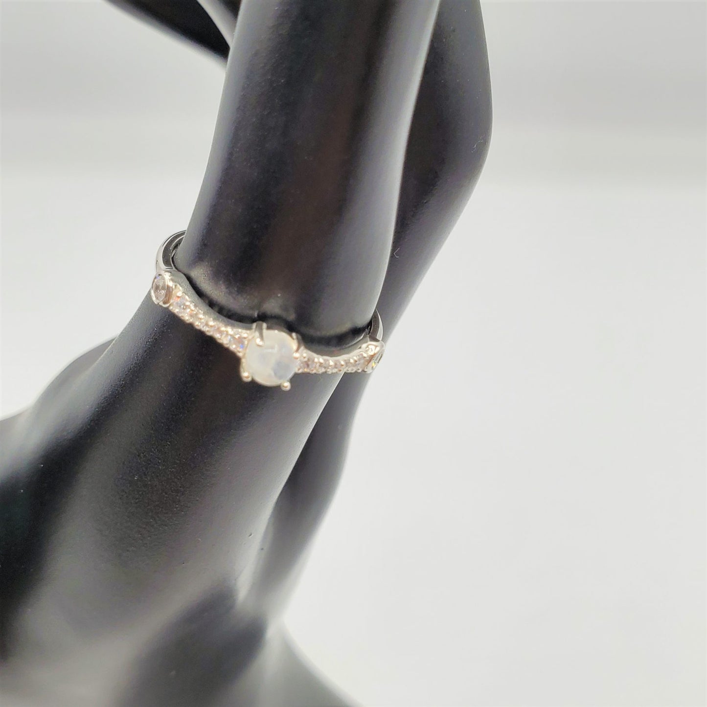 Delicate Moonstone ring with crystal accent stones.