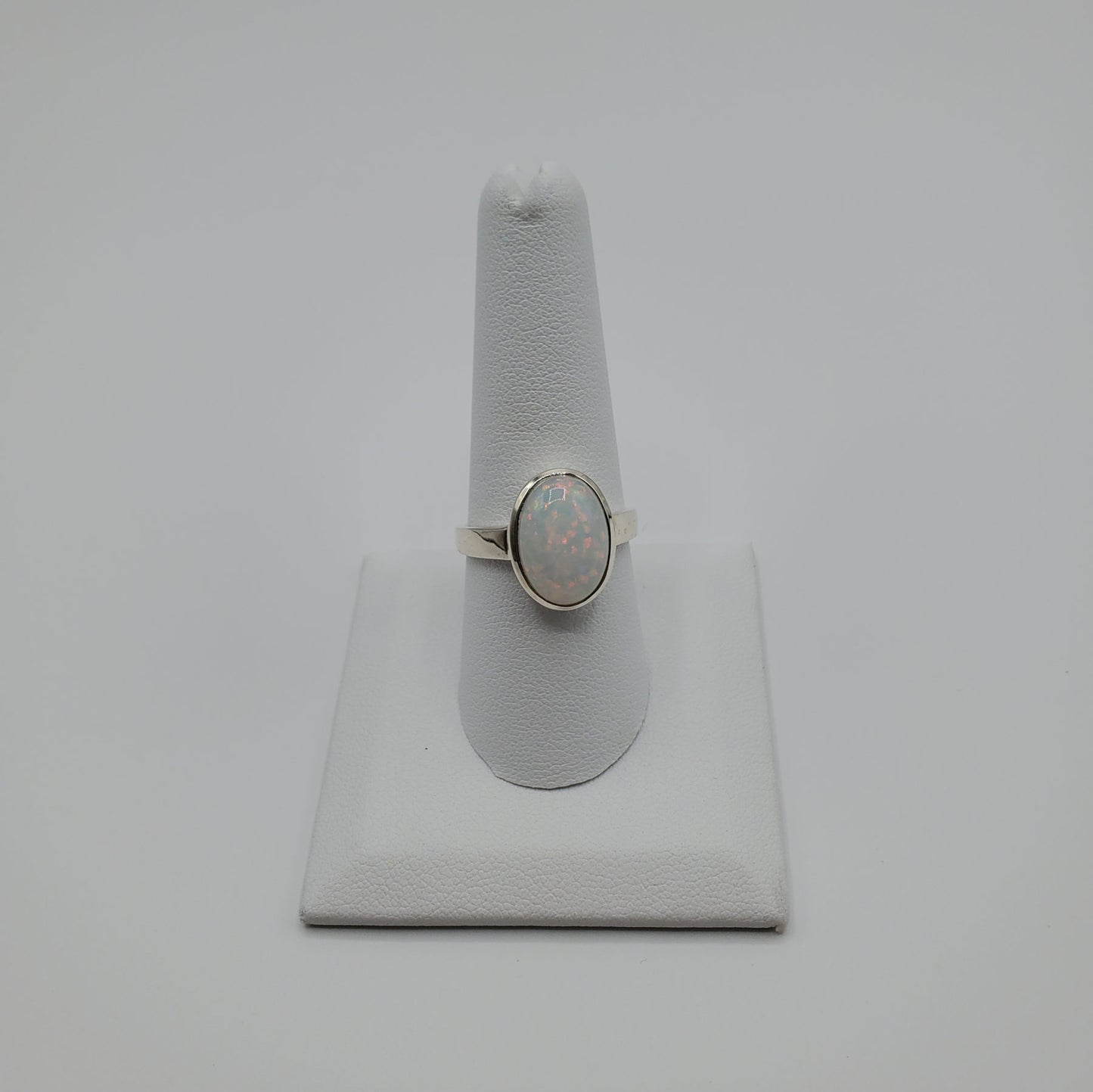 Sparkling Opal cabochon set in .925 Sterling Silver band.