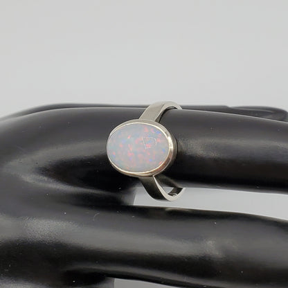 Sparkling Opal cabochon set in .925 Sterling Silver band.