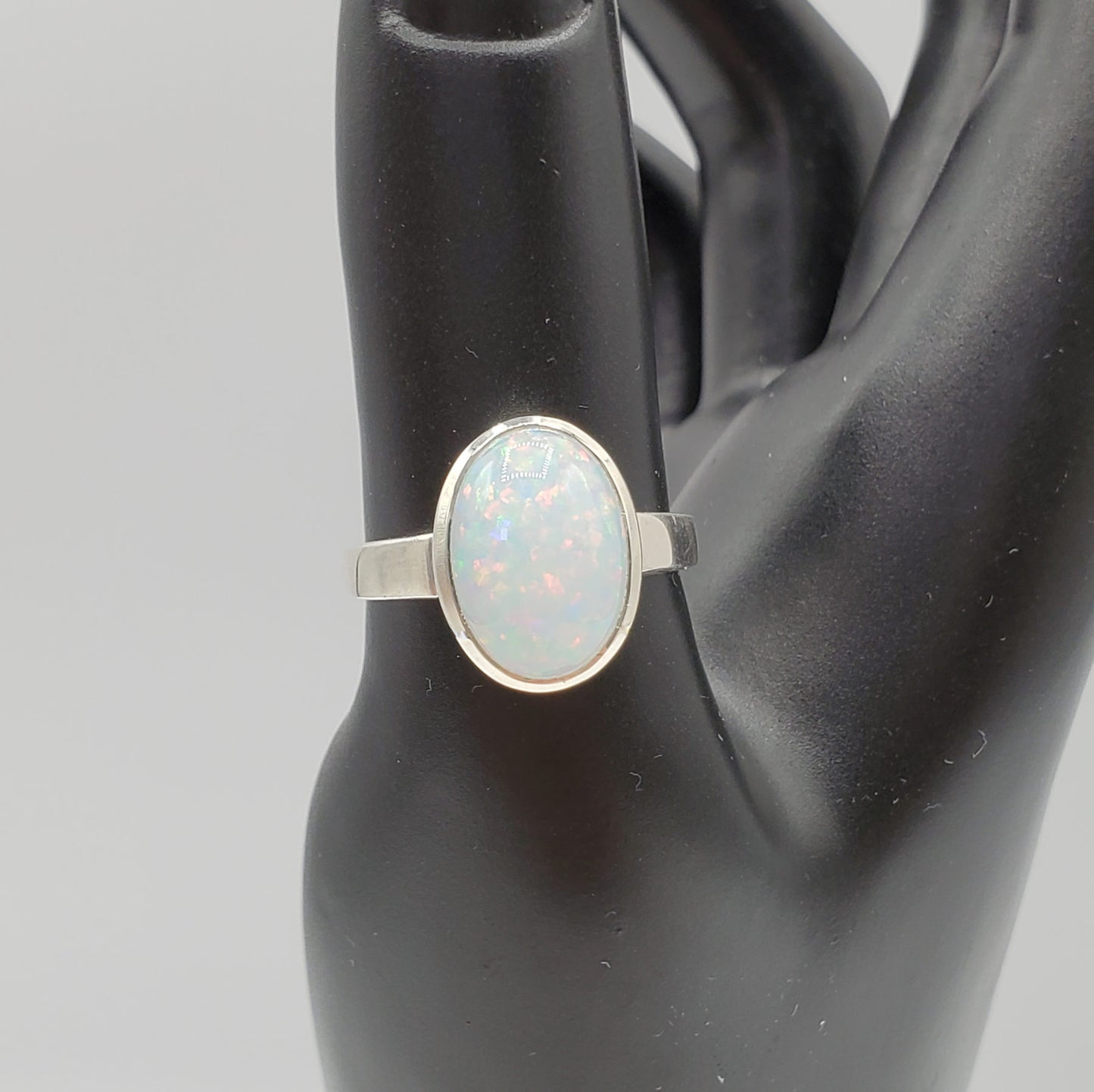 Sparkling Opal cabochon set in .925 Sterling Silver band.