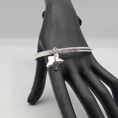 .925 Sterling Silver 3 bangle bracelet accented with a Sterling Silver Star Charm.