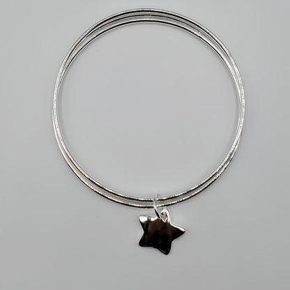 .925 Sterling Silver 3 bangle bracelet accented with a Sterling Silver Star Charm.