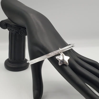 .925 Sterling Silver 3 bangle bracelet accented with a Sterling Silver Star Charm.