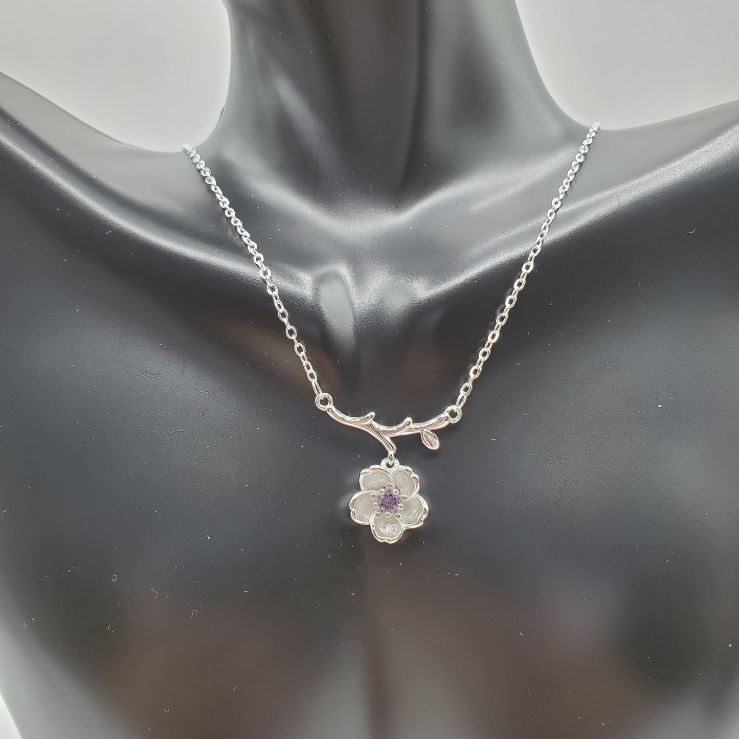 .925 Sterling Silver Jewelry Set of Cherry Blossoms accented by a center stone of amethyst.