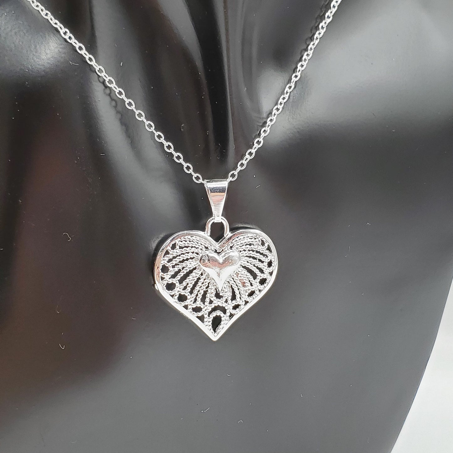 Filigree heart pendant on a 18" sterling silver chain.