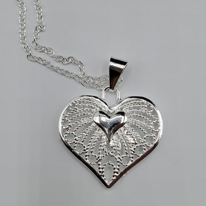 Filigree heart pendant on a 18" sterling silver chain.