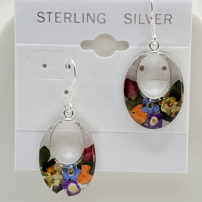 Oval dangle earrings with multi colored flowers.