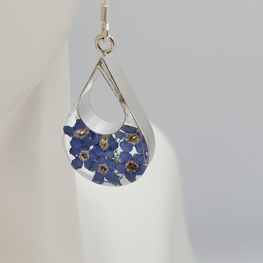 Oval dangle earrings filled with bluebonnet flowers.