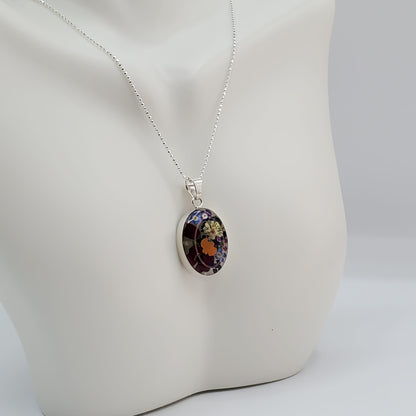 Oval resin pendant with delicate multi colored flowers