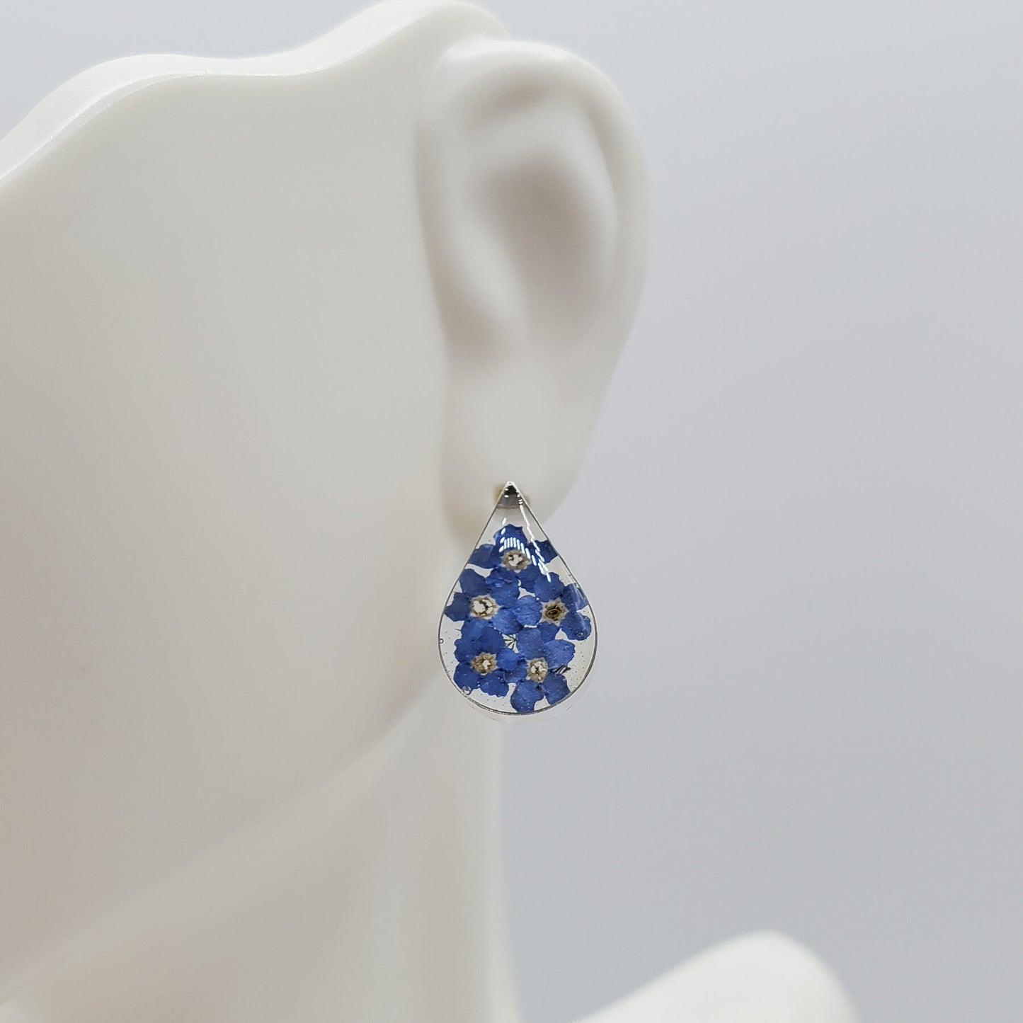 Oval blue bonnet flower stud earrings.