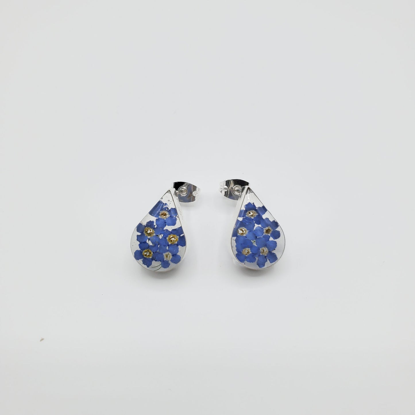 Oval blue bonnet flower stud earrings.