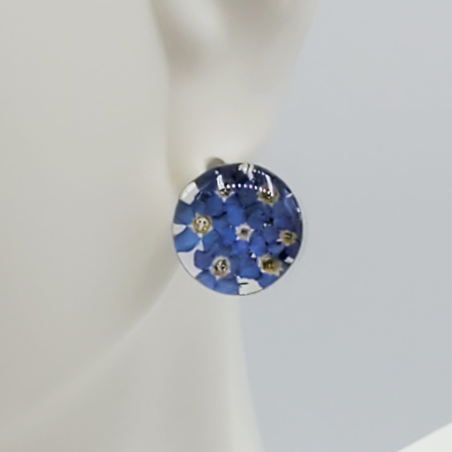 Small round blue bonnet flower stud earrings.