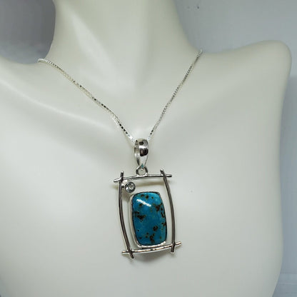 Shattuckite Pendant accented with Light Blue Topaz